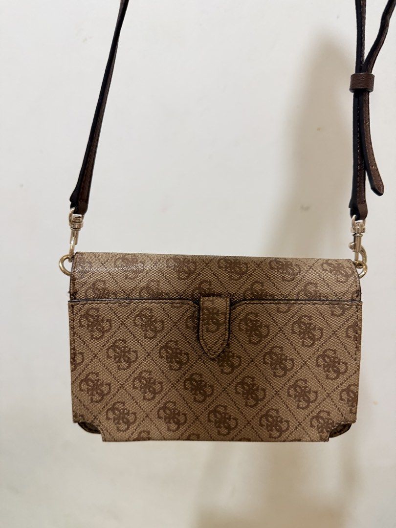 Guess Brown Monogram Crossbody Bag with Wallet Interior (Category: Cross-body Bags) located in Manila. Submitted by reginemariev (Listing ID 1468105371, Image 2). Description: -bought it in guess store and never been used - Brand: Guess - Color: Brown monogram with dark brown adjustable strap - Hardware: Gold-tone hardware with front triangle logo plaque - Design: Practical 2-in-1 crossbody bag and wallet combination - Strap: Removable and adjust