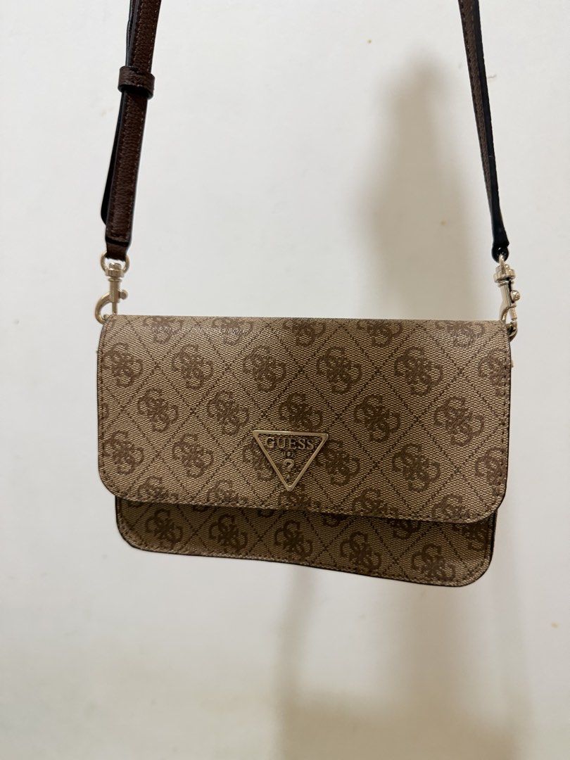 Guess Brown Monogram Crossbody Bag with Wallet Interior (Category: Cross-body Bags) located in Manila. Submitted by reginemariev (Listing ID 1468105371, Image 1). Description: -bought it in guess store and never been used - Brand: Guess - Color: Brown monogram with dark brown adjustable strap - Hardware: Gold-tone hardware with front triangle logo plaque - Design: Practical 2-in-1 crossbody bag and wallet combination - Strap: Removable and adjust