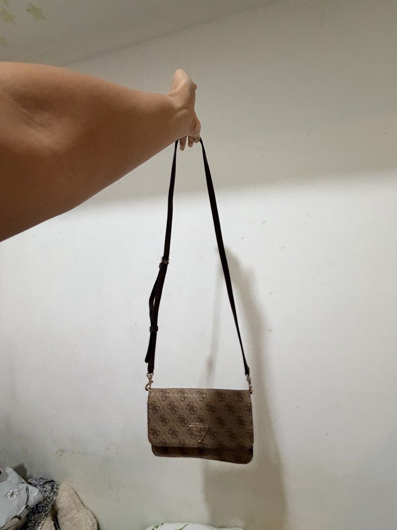 Guess Brown Monogram Crossbody Bag with Wallet Interior (Category: Cross-body Bags) located in Manila. Submitted by reginemariev (Listing ID 1468105371, Image 3). Description: -bought it in guess store and never been used - Brand: Guess - Color: Brown monogram with dark brown adjustable strap - Hardware: Gold-tone hardware with front triangle logo plaque - Design: Practical 2-in-1 crossbody bag and wallet combination - Strap: Removable and adjust