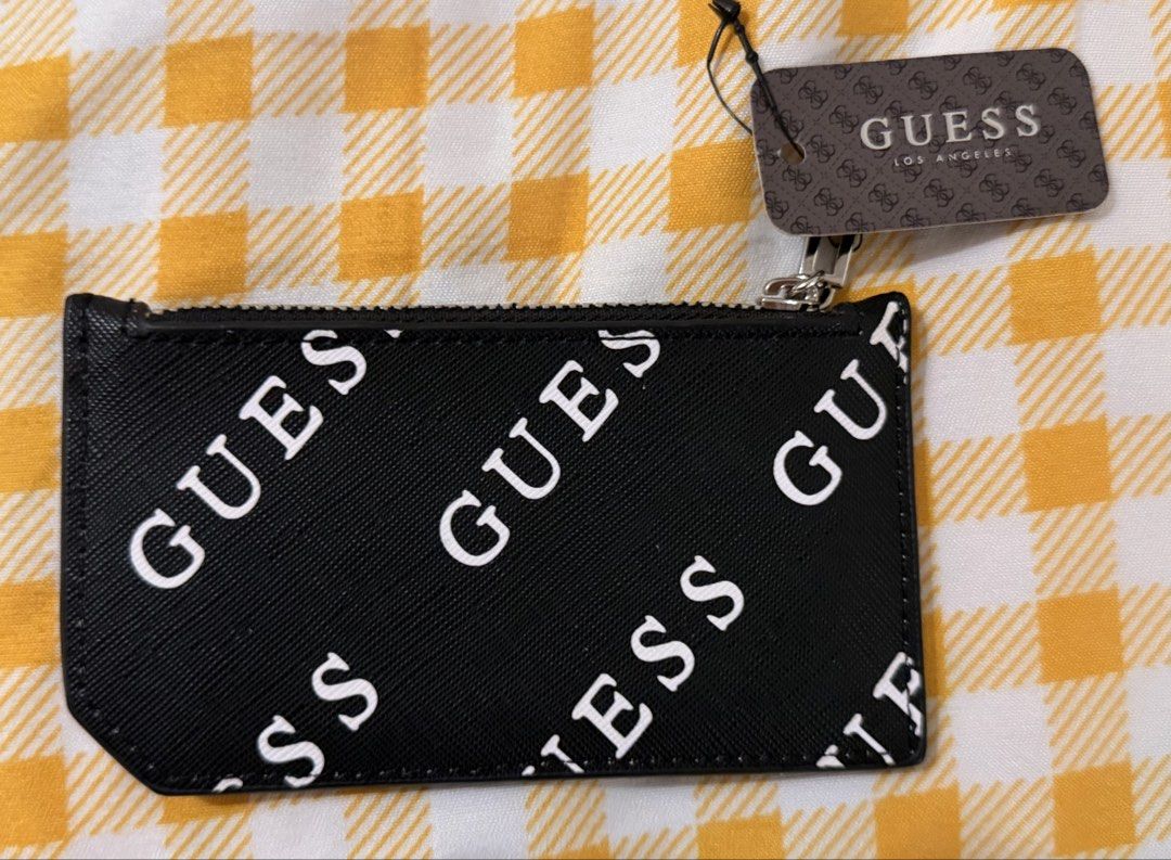 GUESS Luella SLG Card Case Black (Category: Wallets & Card holders) located in Manila. Submitted by nayeoniescart (Listing ID 1468242648, Image 2). Description: GUESS Luella SLG card case BRAND NEW (style P8625594). - Black colorway with white GUESS brand typography print all over. Features multiple card slots on the front and a zippered pocket on top for coins or cash. - Silver-tone metal GUESS Los Angeles logo plaque on front. - Original store 