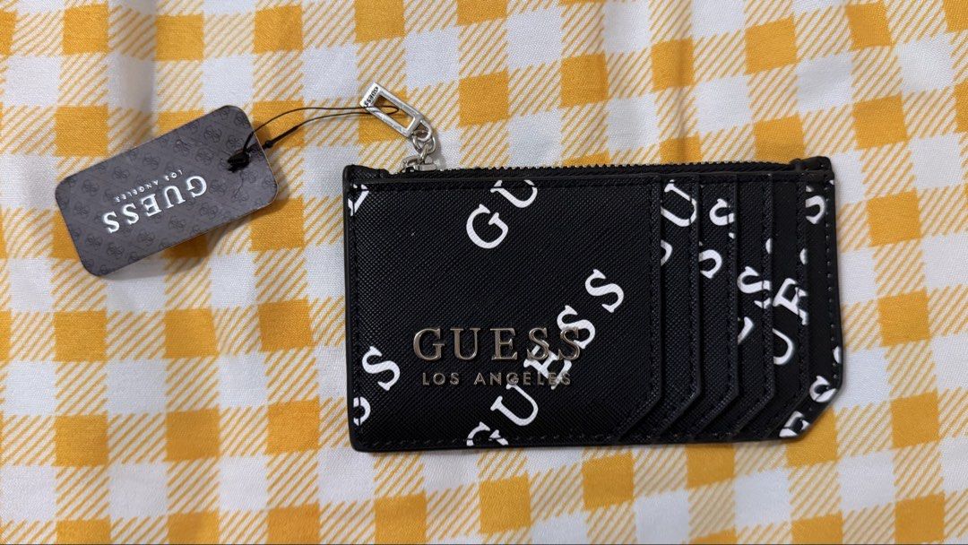 GUESS Luella SLG Card Case Black (Category: Wallets & Card holders) located in Manila. Submitted by nayeoniescart (Listing ID 1468242648, Image 1). Description: GUESS Luella SLG card case BRAND NEW (style P8625594). - Black colorway with white GUESS brand typography print all over. Features multiple card slots on the front and a zippered pocket on top for coins or cash. - Silver-tone metal GUESS Los Angeles logo plaque on front. - Original store 