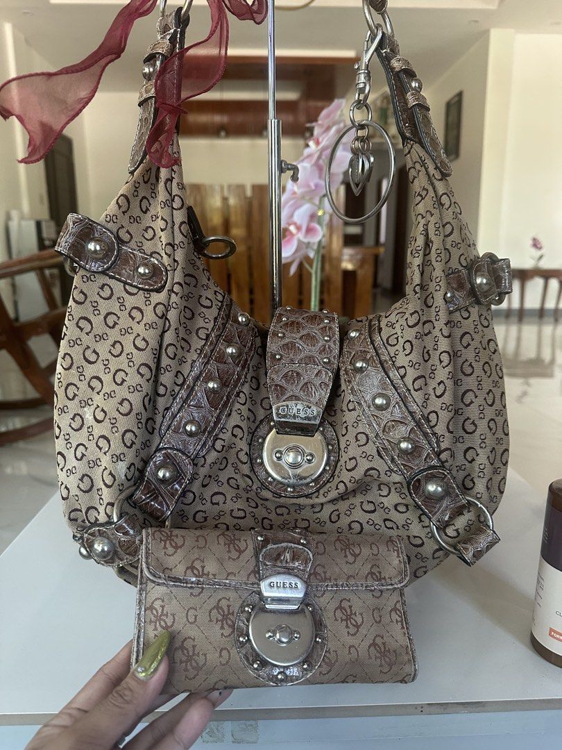 Guess Monogram Shoulder Bag with Matching Wallet (Category: Shoulder Bags) located in Manila. Submitted by goldenhorse-dafc (Listing ID 1468095809, Image 2). Description: Guess shoulder bag covered in the signature brown monogram print. Faux croc-embossed leather trim with silver-toned hardware and stud details. Includes a matching long wallet with a turn-lock closure. Cute maroon ribbon attached to the strap. Silver key ring charm hanging from t