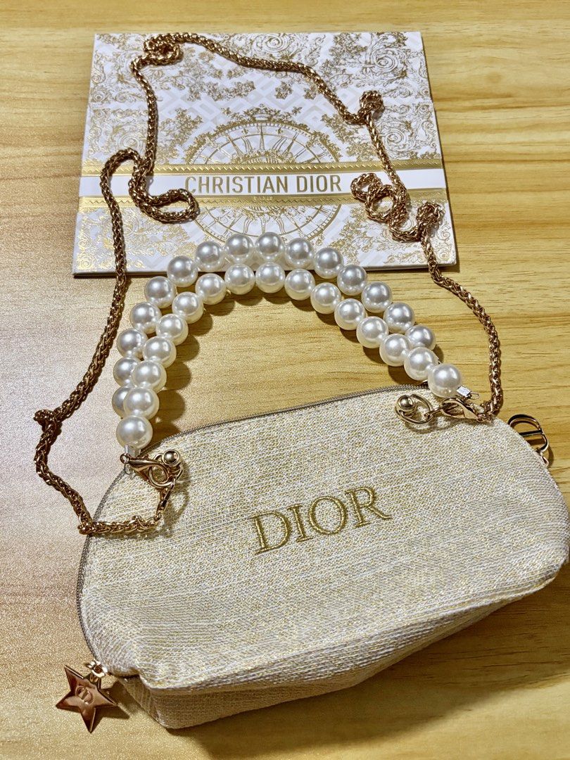 GWP Dior Gold Tone Pearl Handle Pouch Bag (Category: Purses & Pouches) located in Mandaluyong City. Submitted by deevirgo (Listing ID 1468189066, Image 1). Description: GWP - This is a GWP item - gift with purchase. Given to customers with purchase of specific amount of luxury brands . Authentic Christian Dior beauty pouch in white and gold textured fabric - Features an elegant double faux pearl top handle - Includes a detachable chain strap with
