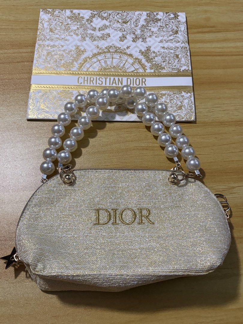 GWP Dior Gold Tone Pearl Handle Pouch Bag (Category: Purses & Pouches) located in Mandaluyong City. Submitted by deevirgo (Listing ID 1468189066, Image 3). Description: GWP - This is a GWP item - gift with purchase. Given to customers with purchase of specific amount of luxury brands . Authentic Christian Dior beauty pouch in white and gold textured fabric - Features an elegant double faux pearl top handle - Includes a detachable chain strap with