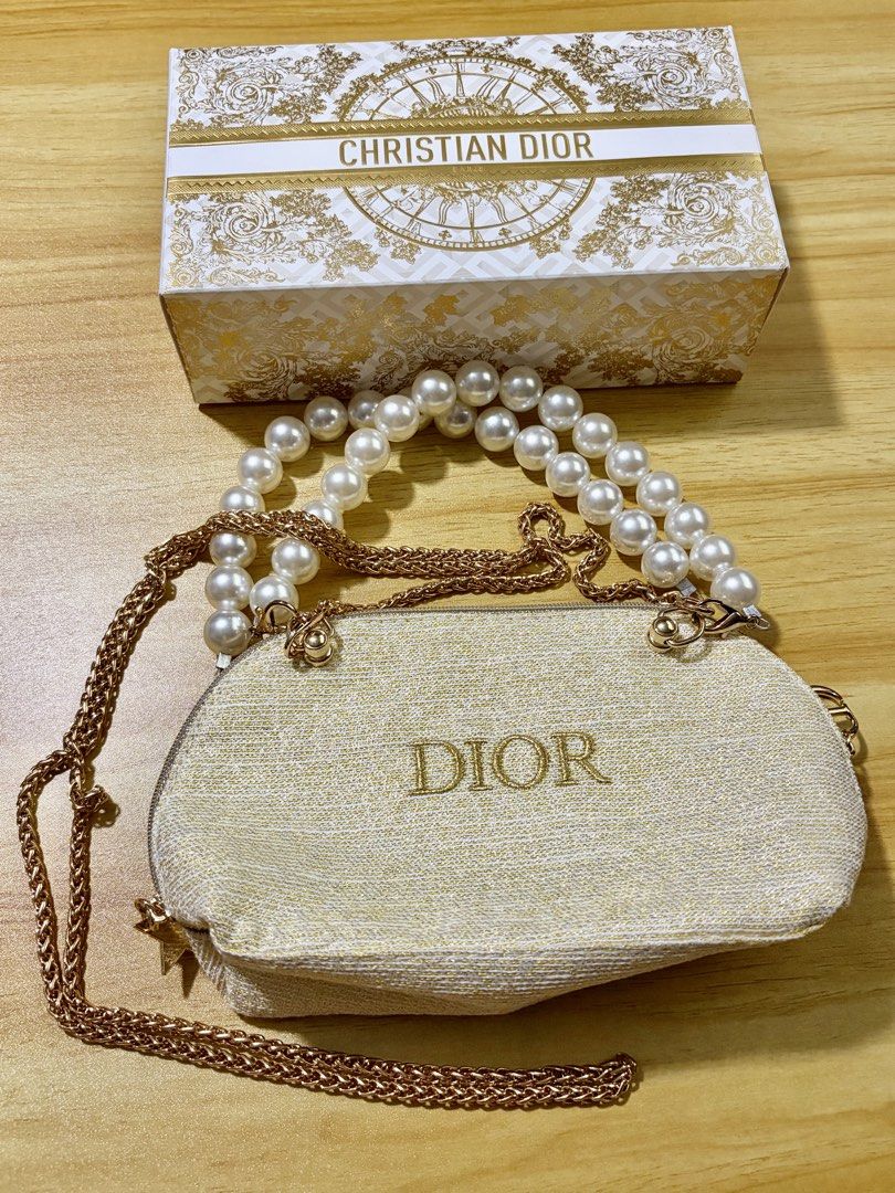 GWP Dior Gold Tone Pearl Handle Pouch Bag (Category: Purses & Pouches) located in Mandaluyong City. Submitted by deevirgo (Listing ID 1468189066, Image 2). Description: GWP - This is a GWP item - gift with purchase. Given to customers with purchase of specific amount of luxury brands . Authentic Christian Dior beauty pouch in white and gold textured fabric - Features an elegant double faux pearl top handle - Includes a detachable chain strap with