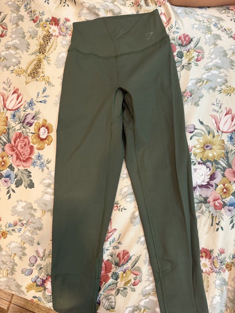 Gymshark Green Leggings (Category: Activewear) located in Manila. Submitted by bellafleur (Listing ID 1468197280, Image 1). Description: - Brand: Gymshark - Color: Dark green - Rise: High-waisted with supportive leg seaming - Branding: Gymshark sharkhead logo on upper front waistband - Material: Smooth, stretchy, and flexible performance fabric - Condition: Excellent, clean surface with no stains or visible wear.