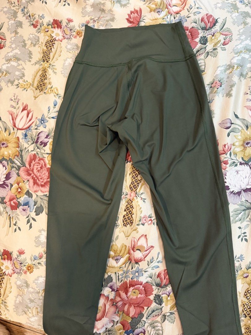 Gymshark Green Leggings (Category: Activewear) located in Manila. Submitted by bellafleur (Listing ID 1468197280, Image 2). Description: - Brand: Gymshark - Color: Dark green - Rise: High-waisted with supportive leg seaming - Branding: Gymshark sharkhead logo on upper front waistband - Material: Smooth, stretchy, and flexible performance fabric - Condition: Excellent, clean surface with no stains or visible wear.