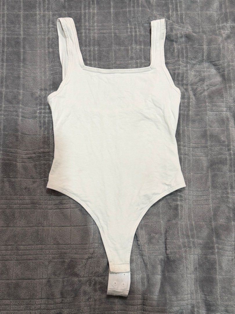 Gymshark White Square Neck Thong Bodysuit Size S (Category: Sleeveless) located in Bulacan. Submitted by richelleregala (Listing ID 1468078685, Image 1). Description: - Brand: Gymshark - Style: Square neck bodysuit - Color: White - Size: S - Material: 95% cotton, 5% elastane (soft stretch fabric) - Details: Thong cut, snap button closure, small silver heat-sealed logo near neckline.
