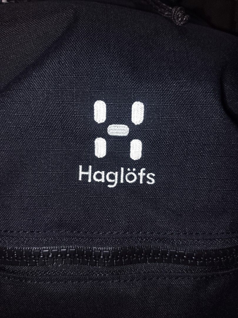 Haglöfs Black Backpack with Orange Interior (Category: Backpacks) located in San Juan City. Submitted by swiftfox.62e2f4 (Listing ID 1468138240, Image 3). Description: - Brand: Haglöfs - Color: Black with bright yellow-orange inner lining - Condition: Clean exterior, sturdy build - Comfort & Support: Mesh back panel, padded shoulder straps, and adjustable sternum strap with buckle - Storage & Pockets: Spacious main compartment, heavy-duty front z