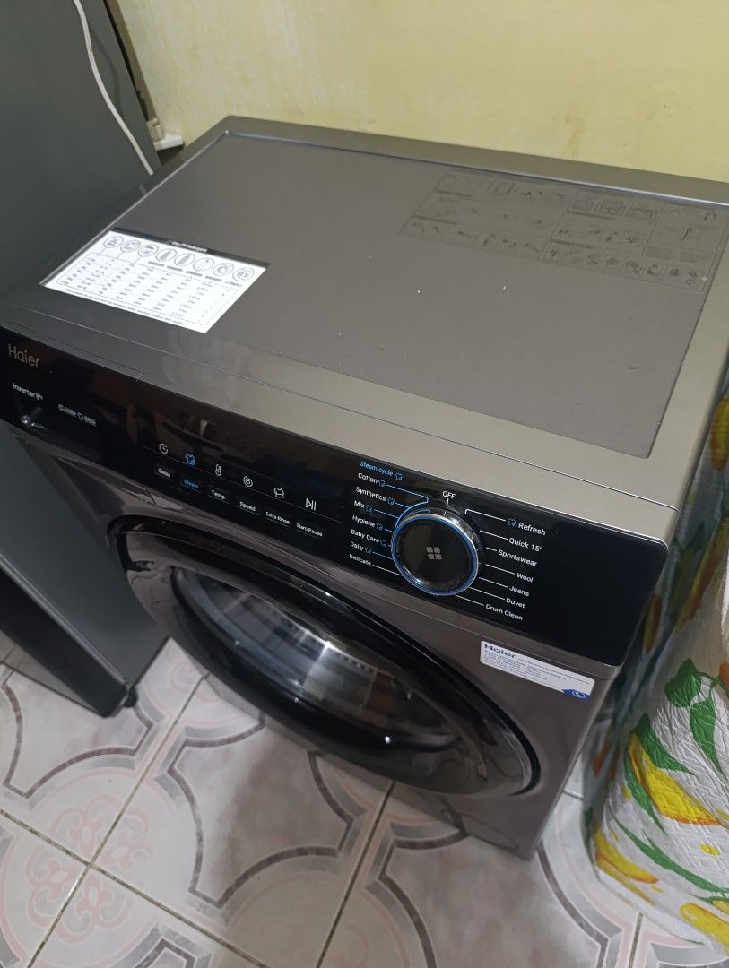 Haier Inverter Front Load Washing Machine (Category: Washing Machines and Dryers) located in Pasig City. Submitted by lucky.avalonchanel (Listing ID 1468133179, Image 3). Description: - Brand/Model: Haier Front Load Inverter Washing Machine (8kg capacity) - Color: Stylish dark grey with a black-rimmed transparent glass door - Control Panel: Modern digital dial with touch controls on the top right - Wash Cycles: Includes Cotton, Quick 15, Wool, Hy