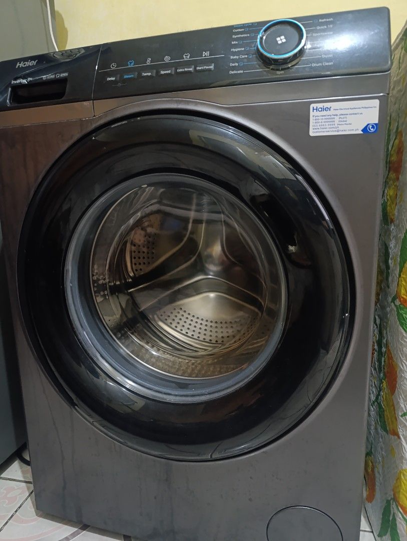 Haier Inverter Front Load Washing Machine (Category: Washing Machines and Dryers) located in Pasig City. Submitted by lucky.avalonchanel (Listing ID 1468133179, Image 2). Description: - Brand/Model: Haier Front Load Inverter Washing Machine (8kg capacity) - Color: Stylish dark grey with a black-rimmed transparent glass door - Control Panel: Modern digital dial with touch controls on the top right - Wash Cycles: Includes Cotton, Quick 15, Wool, Hy