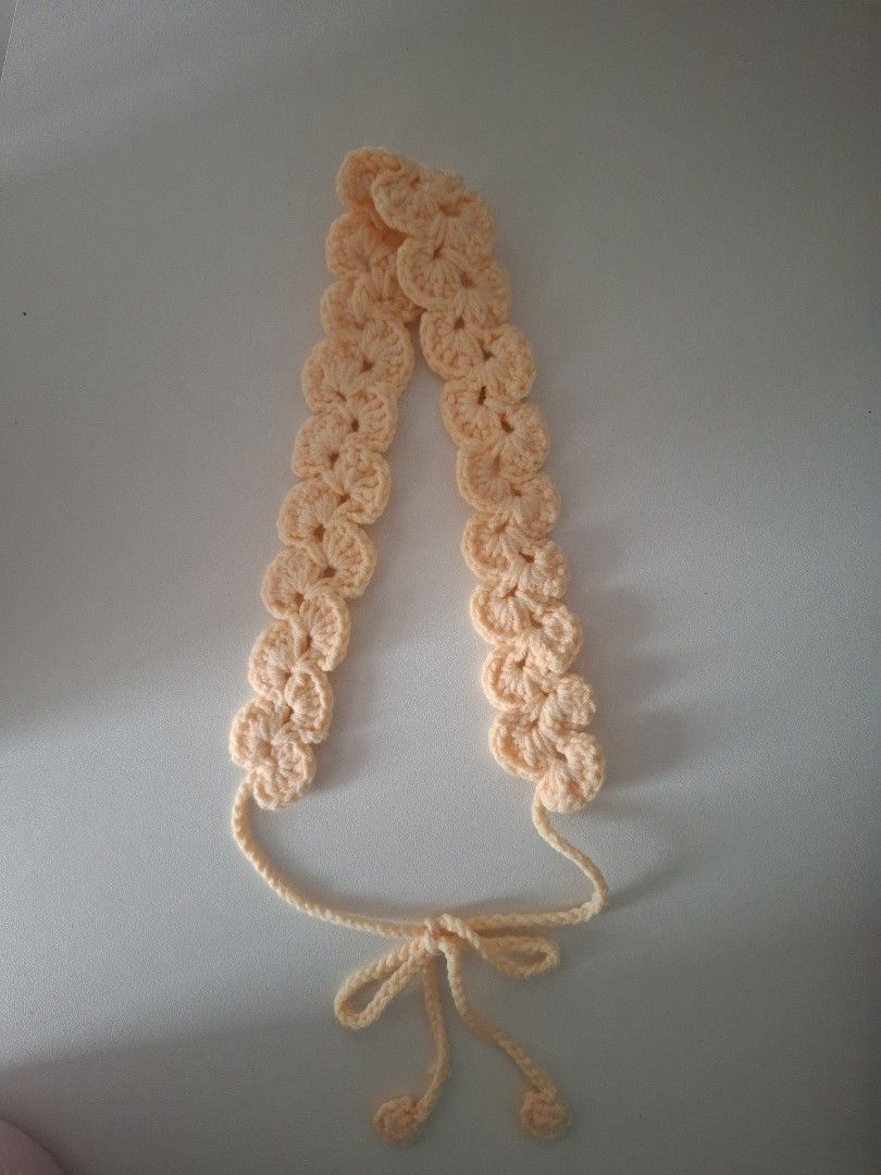 Handmade crochet headband with tie straps (Category: Hair Accessories) located in Cavite. Submitted by sheeeki_ (Listing ID 1468093534, Image 1). Description: - Made to order - Yarn color options: light blue, coffee brown, light pink, light yellow, cream, - Material: Soft yarn texture - Design: Scalloped pattern with adjustable tie-back straps and pompom ends - Style: Handmade crochet, ideal for everyday casual wear - Buyer covers the SF through 