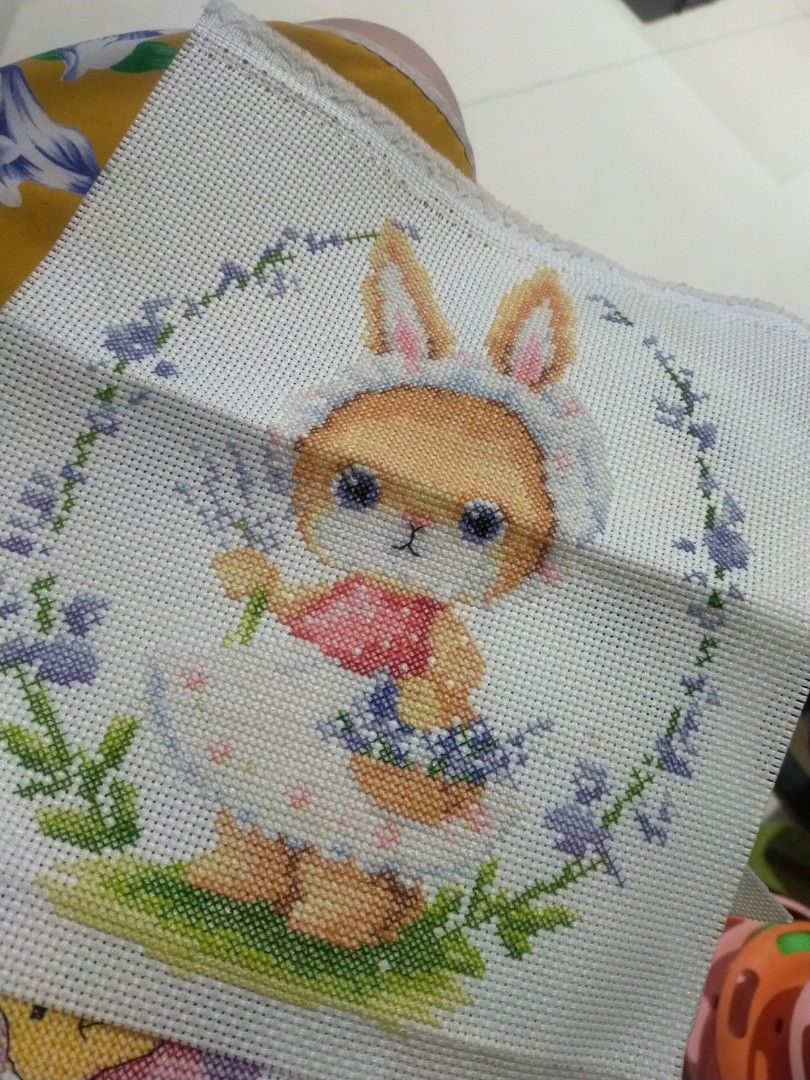 Handmade Cross Stitch Embroidery Bunny Rabbit Design (Category: Handmade Craft) located in Pagadian. Submitted by kimygo (Listing ID 1468157365, Image 1). Description: - Design: Cute bunny rabbit surrounded by vibrant flowers and greenery - Material: Stitched on clean white aida cloth - Quality: Features neat stitching with bright, cheerful colors - Uses: Great for custom framing, making a small accent pillow, or DIY crafting.