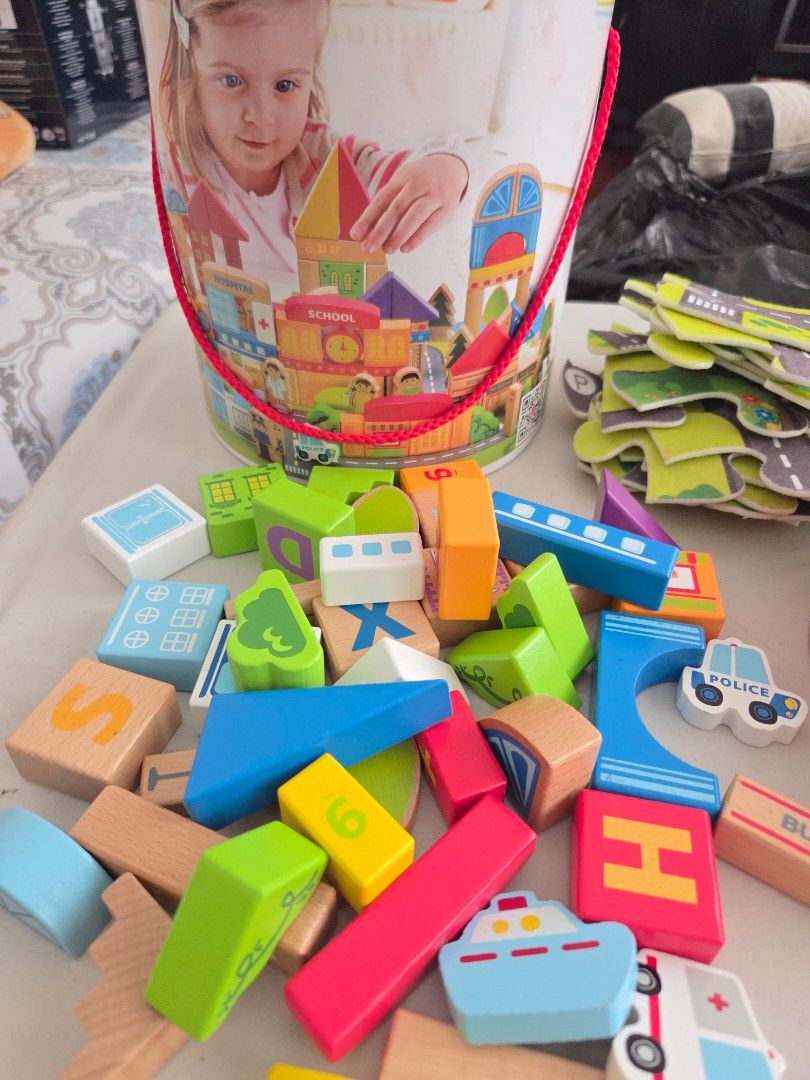 Hape City Building Blocks Set with Puzzle Playmat (Category: Educational & Learning Toys) located in Quezon City. Submitted by robin.t (Listing ID 1468090793, Image 2). Description: - Brand: Hape City Building Blocks - Includes colorful wooden blocks for building towns, hospitals, schools, and police stations - Comes with puzzle playmat pieces to create fun road and city layouts - Encourages imaginative play and creativity for kids - Packed in a 