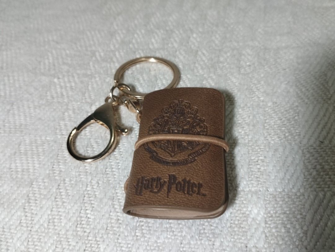 Harry Potter Leather Mini Book Keychain (Category: Western Merchandise) located in Cagayan de Oro. Submitted by pochimart (Listing ID 1468237138, Image 1). Description: A keychain for a potterhead! 🐇 🧡✨ (Check Images Please) ⭐₱80 ✉️Message me if you're interested or have questions, I'm happy to help! 📍Location: CDO / Cagayan De Oro (we can meet up if we're close) 🚚J&T - Message me (buyer covers the shipping fee) 💳GCash.