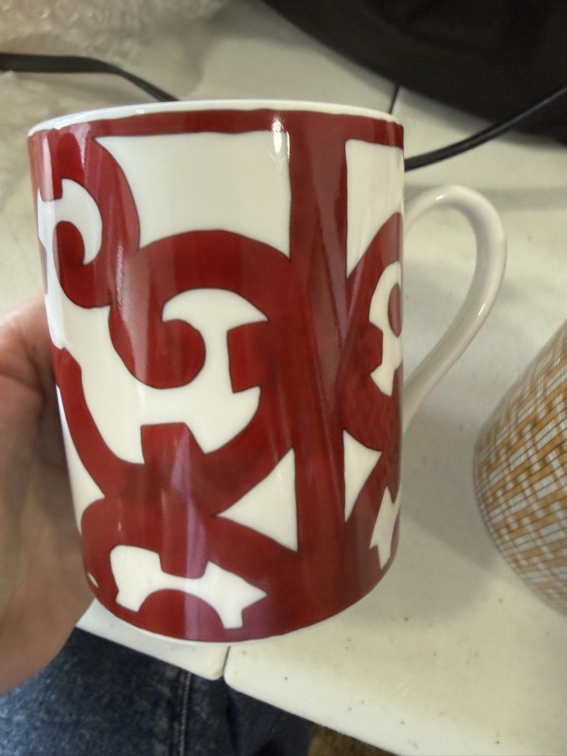 Hermes Balcon Mug (Category: Coffee & Tea Tableware) located in Makati City. Submitted by dgcurated09 (Listing ID 1468222591, Image 1). Description: No box Ceramic coffee mug with bold red abstract pattern on a white background. Interior features two red rings near the rim. Sturdy handle on the side. Clean interior and exterior, no chips or cracks found..