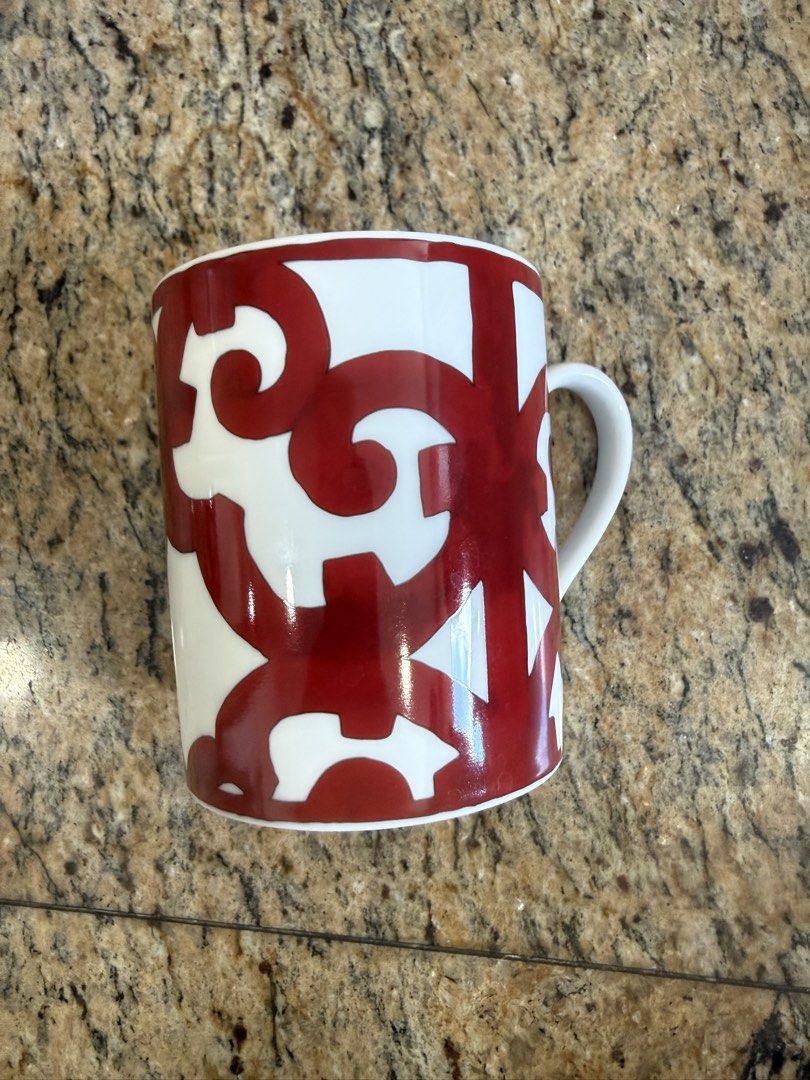 Hermes Balcon Mug (Category: Coffee & Tea Tableware) located in Makati City. Submitted by dgcurated09 (Listing ID 1468222591, Image 2). Description: No box Ceramic coffee mug with bold red abstract pattern on a white background. Interior features two red rings near the rim. Sturdy handle on the side. Clean interior and exterior, no chips or cracks found..