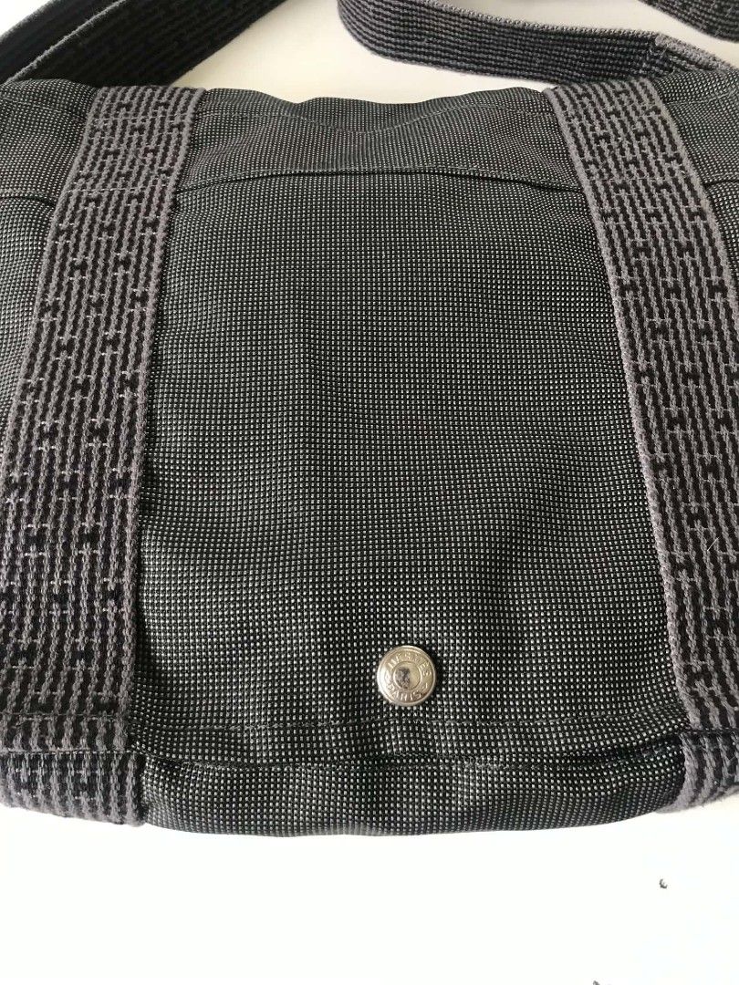 Hermes Herbag Messenger Bag Grey Polyamide (Category: Sling Bags) located in Midsayap. Submitted by purse_gedo (Listing ID 1468144056, Image 2). Description: - Brand: Hermes - Color: Dark Grey - Material: Durable polyamide and polyester blend (Made in France) - Closure: Flap with snap button - Strap: Adjustable for shoulder or crossbody wear - Condition: Clean inside and outside - Perfect for daily commute or casual outings.