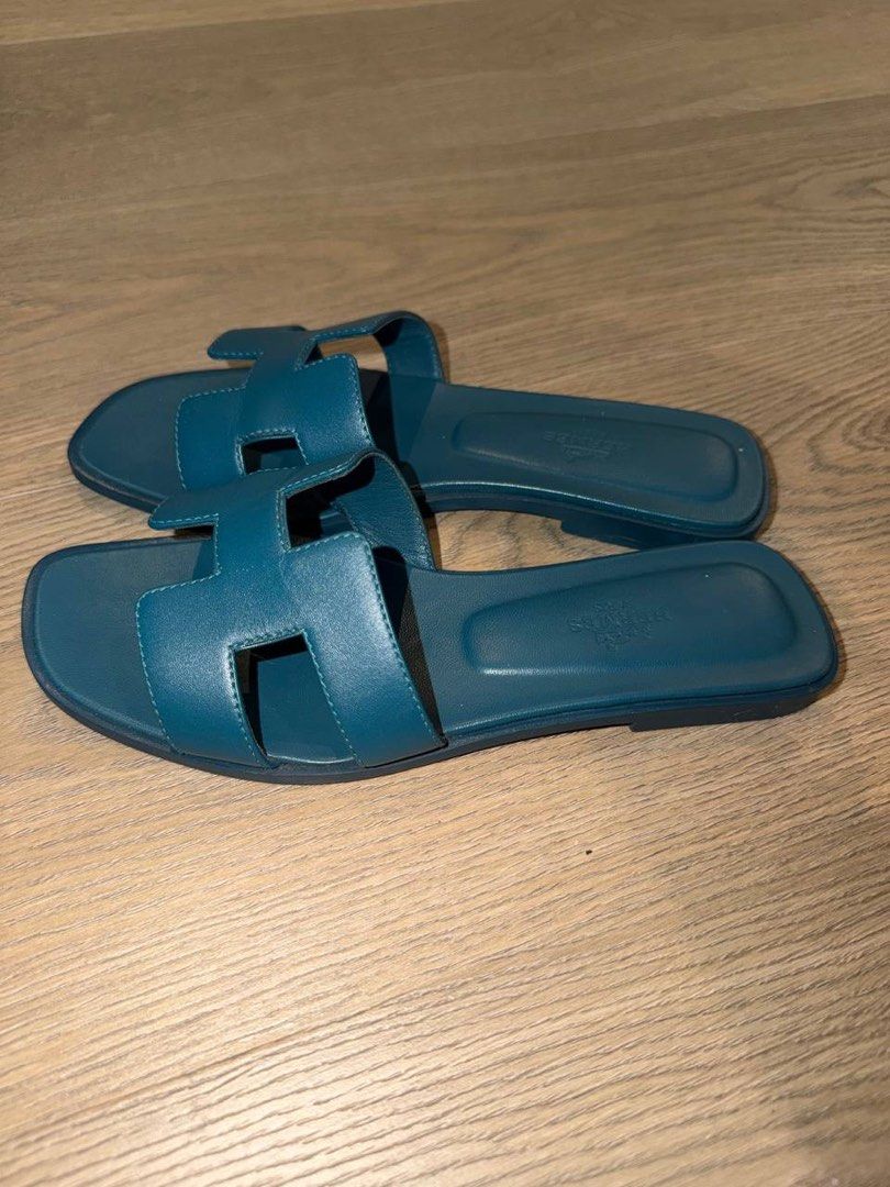 Hermes Oran Sandals Blue Size 36 (Category: Sneakers & Footwear) located in Manila. Submitted by carolinegaweco (Listing ID 1468154448, Image 3). Description: - Brand: Hermes - Style: Oran Sandals - Color: Teal Blue - Size: 36 - Condition: Excellent, clean insoles with clear hot stamp, soles show only very light wear from indoor try-ons - Features: Classic H-cutout strap, easy slip-on design - Perfect for stylish summer wear and everyday luxury.