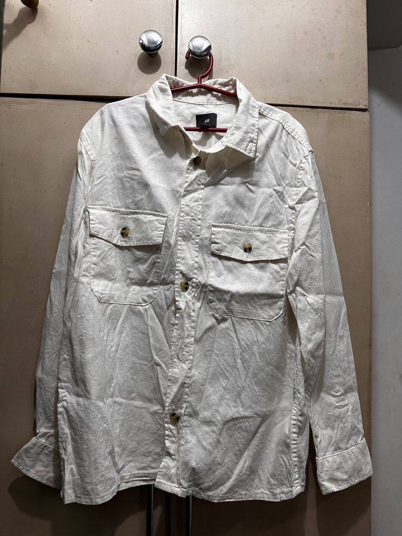 H&M White Long Sleeve Button-Down Shirt Size M (Category: Longsleeves) located in Manila. Submitted by vicnoay (Listing ID 1468278917, Image 1). Description: - Brand: H&M - Style: Long sleeve button-down shirt - Size: M (regular fit) - Details: Two front flap pockets with buttons, tortoise shell front buttons - Condition: Clean, basic piece - Best for: Casual wear or layering - Versatile wardrobe staple.