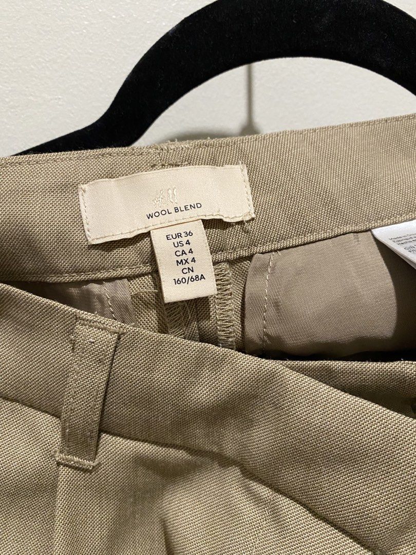 H&M Wool Blend Trousers (Category: Trousers) located in Davao. Submitted by decluttering.dvo (Listing ID 1468089603, Image 3). Description: - Brand/Model: H&M wool blend tailored trousers - Color: Dark Beige - Size: EUR 36, US 4 - Fit & Details: Tailored fit, pleated front, belt loops - Closure & Pockets: Standard zip and button closure, functional side pockets - Condition: Clean material with a well-structured silhouette.