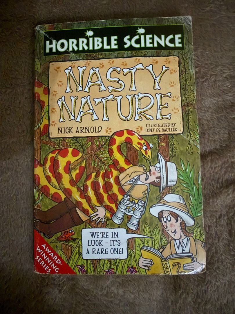 Nasty Nature Nick Arnold (Category: Storybooks) located in Manila. Submitted by vaultfinds (Listing ID 1468213178, Image 1). Description: Horrible Science Nasty Nature book by Nick Arnold. Illustrated by Tony De Saulles. Award-winning series. Great read for kids who love quirky science facts. Cover shows a yellow and red snake wrapped around an explorer. Pages intact, readable copy with some shelf wear on the edges..