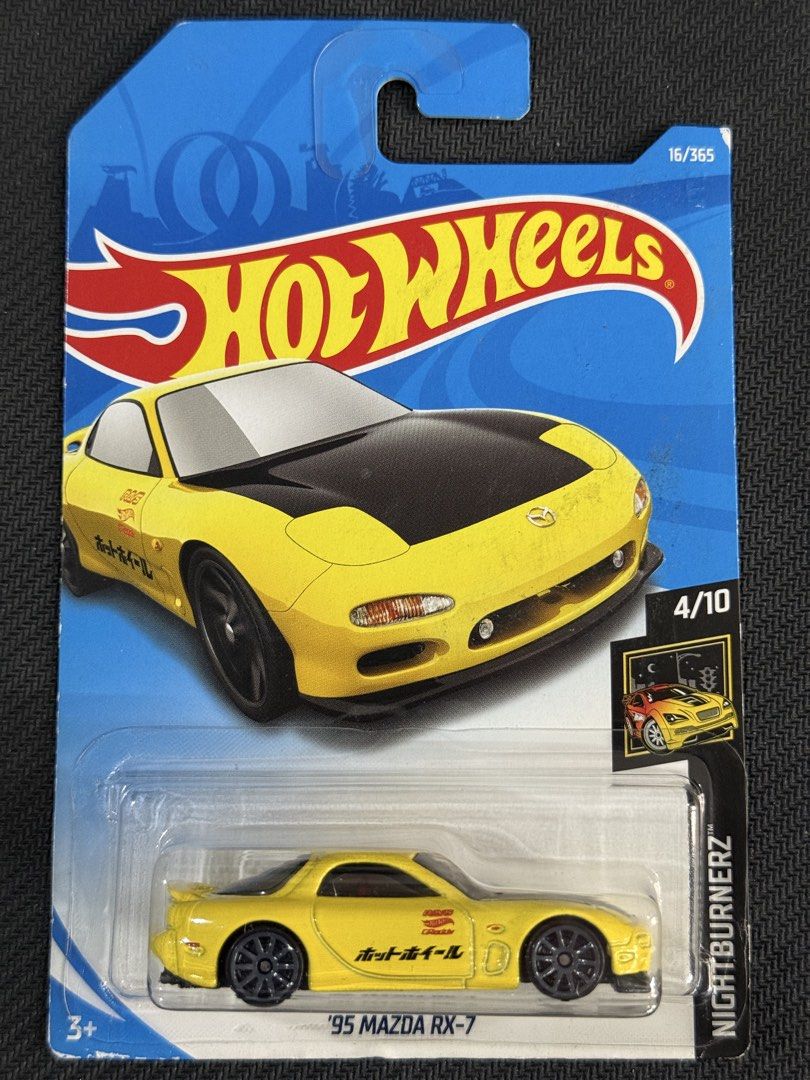 Hot Wheels '95 Mazda RX-7 (Category: Vehicle & Diecast Models) located in Muntinlupa City. Submitted by eman_garcia_ (Listing ID 1468273464, Image 1). Description: - Brand: Hot Wheels - Model: '95 Mazda RX-7 (Nightburnerz Series) - Details: Vibrant yellow body, black hood, dark grey wheels, and Japanese script side graphics - Rarity: #4 of 10 in the series, #16 of 365 mainline release - Condition: Brand new, unopened in original blister card - Pe