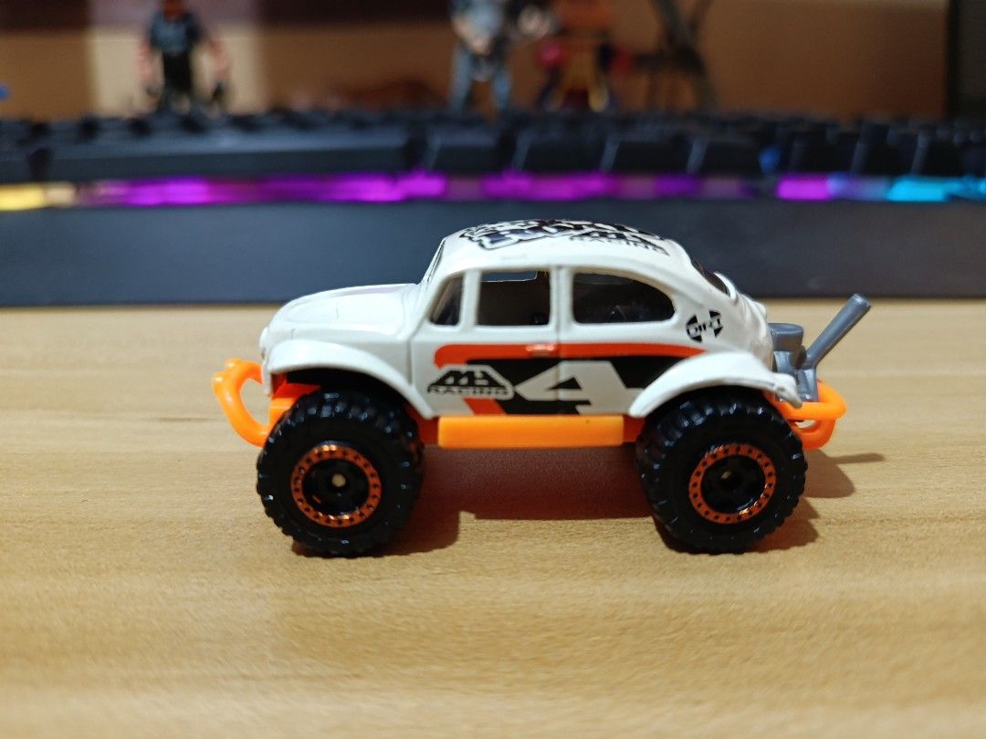 Hot Wheels Off-Road Beetle Toy Car (Category: Vehicle & Diecast Models) located in Ligao. Submitted by travis40 (Listing ID 1468245567, Image 1). Description: - Hot Wheels Baja Beetle toy car (White & Orange) - Off-road monster truck style with chunky black tires - Stylish copper-accented rims - Cool MB Racing side graphics and raised rear exhaust pipe - Perfect collectible for VW Beetle and diecast fans - Condition: Brand new / Mint (as pictured