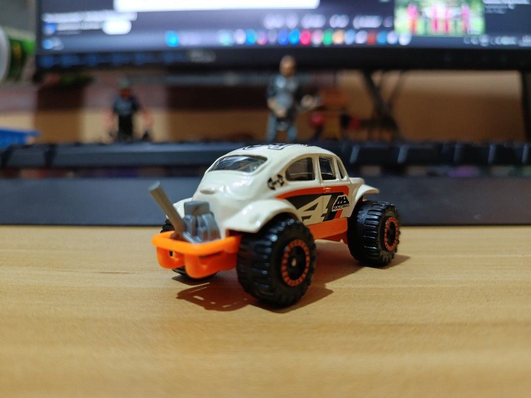 Hot Wheels Off-Road Beetle Toy Car (Category: Vehicle & Diecast Models) located in Ligao. Submitted by travis40 (Listing ID 1468245567, Image 3). Description: - Hot Wheels Baja Beetle toy car (White & Orange) - Off-road monster truck style with chunky black tires - Stylish copper-accented rims - Cool MB Racing side graphics and raised rear exhaust pipe - Perfect collectible for VW Beetle and diecast fans - Condition: Brand new / Mint (as pictured
