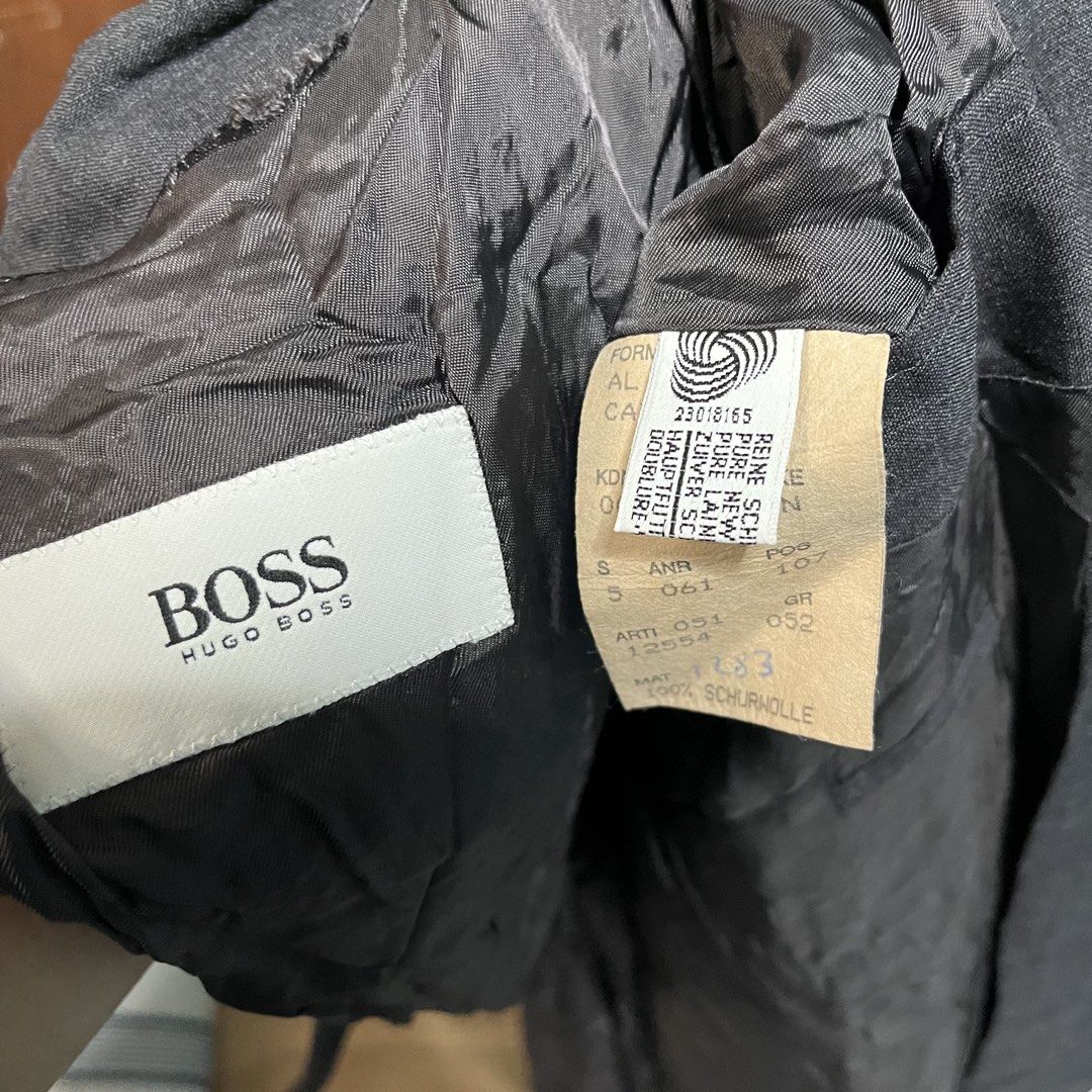 Hugo Boss Double Breasted Wool Blazer Jacket Dark Grey (Category: Coats, Jackets and Outerwear) located in Manila. Submitted by thriftyyyyy. (Listing ID 1468112694, Image 2). Description: - Brand: Hugo Boss - Color: Dark Grey - Material: 100% Pure New Wool - Size: Tag size 52 - Fit: Classic tailored fit - Details: Double-breasted, front button closure, side flap pockets, fully intact interior lining - Condition: Good, needs a steam iron due to st