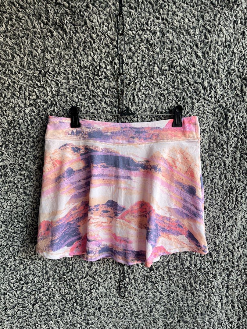 Ideology activewear skort. | Size XL (Category: Skirts) located in General Trias. Submitted by zrchustle.604 (Listing ID 1468281434, Image 1). Description: Ideology activewear skort. It features a colorful, multi-toned landscape print that resembles mountains at sunset, blending shades of pink, purple, orange, and white. Designed for athletic activities like tennis, golf, or running, it includes a wide comfort waistband and built-in liner shorts 