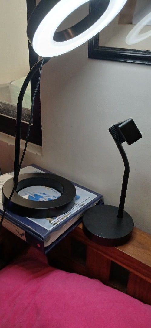 Ikea Ring Lamp with Phone Holder (Category: Lighting) located in Marikina City. Submitted by darthvader888 (Listing ID 1468093020, Image 2). Description: - Brand: IKEA LÅNESPELARE Ring Lamp - Color: Sleek black design - Features: Attached flexible gooseneck phone holder and inline control switch - Lighting: Circular LED ring with bright, adjustable settings - Power: USB-powered cable - Build: Sturdy weighted round base for desk stability - Condit