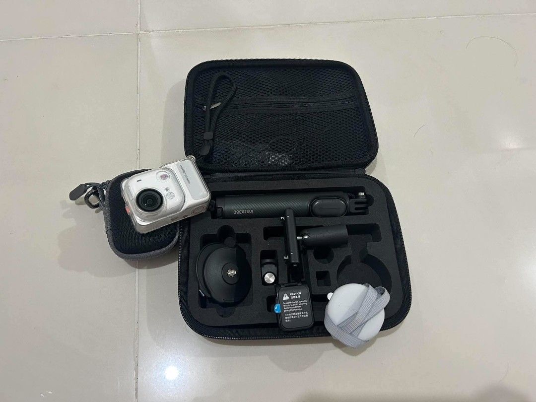 Insta360 GO Ultra action camera with accessories kit (Category: Video Cameras) located in Manila. Submitted by steverrive65874 (Listing ID 1468205336, Image 2). Description: - Insta360 GO Ultra action camera set - Includes charging case, selfie stick, mounts, and lanyard strap - Comes with protective storage case and original packaging box - Everything neatly organized in a custom foam case - Ideal and ready-to-use setup for vlogging and travel c