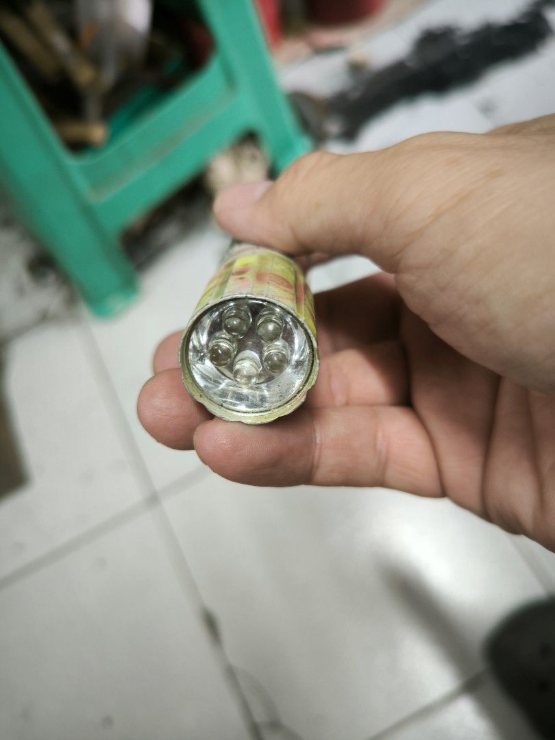 Japan surplus Compact LED Flashlight with Multi-Bulb Head (Category: Lighting) located in Angeles City. Submitted by yellowbrickstore (Listing ID 1468093812, Image 2). Description: - Type: Compact metal flashlight - Condition: Tested and 100% working, clean battery compartment - Lighting: 5 bright white LED bulbs - Design: Cylindrical body with yellow and silver Japanese-patterned tape - Best for: Camping, emergency kits, power outages, and dark 