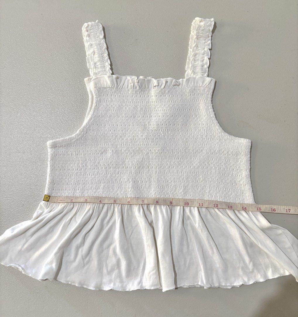 Jeff & Co White Smocked Tank Top (Category: Sleeveless) located in Guimba. Submitted by huenited (Listing ID 1468071540, Image 2). Description: - Brand: Jeff & Co. - Color: White - Condition: Brand new with tags (never worn) - Features: Ruffled straps, stretchy smocked bodice, and flared peplum hem - Perfect basic top for warm weather.