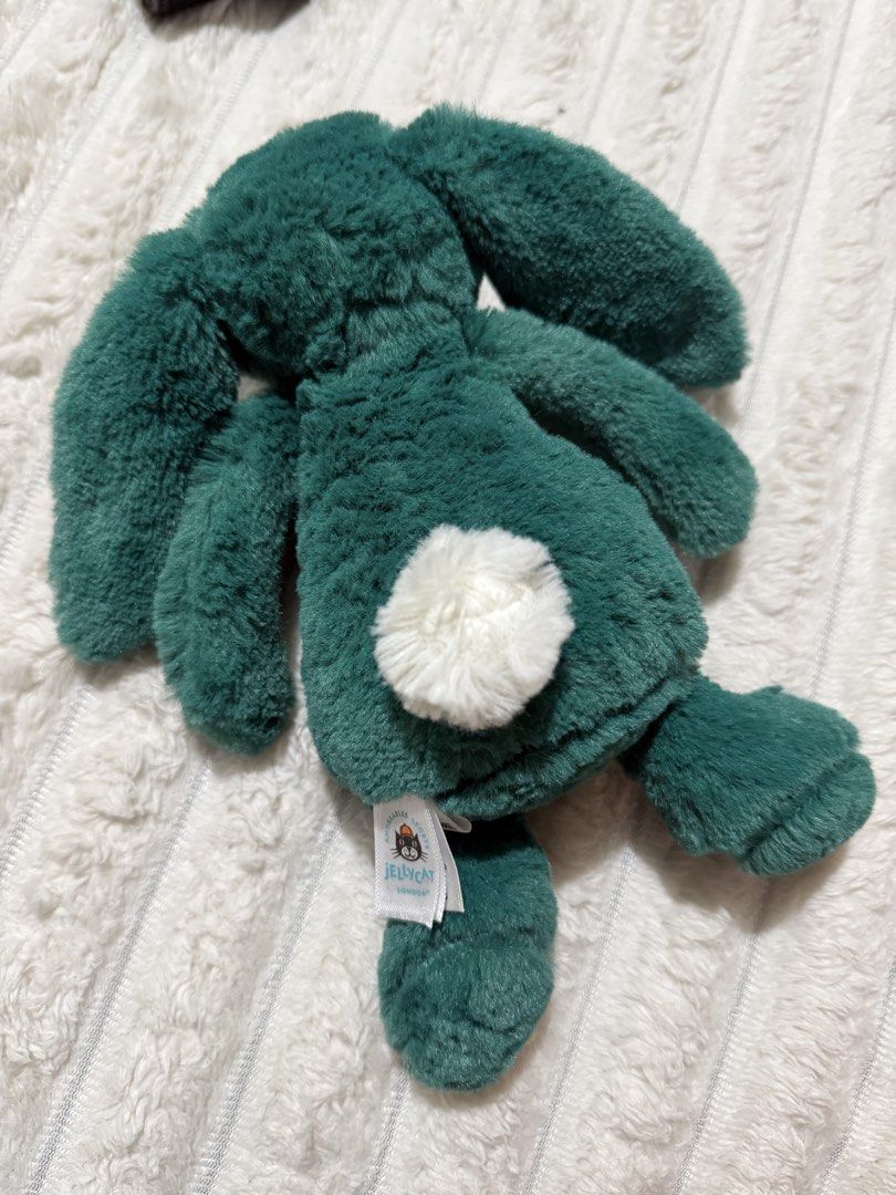 Jellycat Forest Green Bunny Plush (Category: Plushies & Soft Toys) located in Las Pinas. Submitted by yourboki.2026 (Listing ID 1468146372, Image 2). Description: - Brand: Jellycat Stuffed Bunny - Color: Dark green with a fluffy white tail and pink nose - Material: Super soft plush fur with floppy ears - Condition: Excellent, clean, no stains or damage - Special Feature: Original tag attached at the base.
