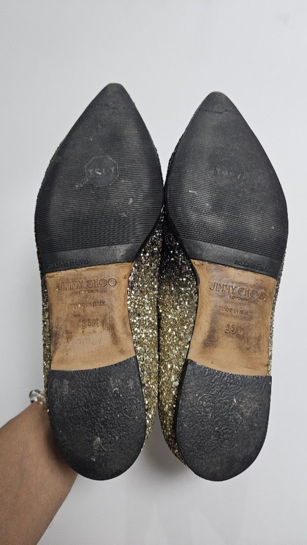 Jimmy Choo Glitter Pointed Toe Flats (Category: Flats & Sandals) located in Alfonso. Submitted by jbcamet (Listing ID 1468192679, Image 3). Description: - Brand: Jimmy Choo - Style: Pointed toe flats with stunning black-to-gold glitter fade - Size: 35.5 - Material: Leather lining and soles, crafted in Italy - Condition: Glitter exterior is fully intact; normal wear on the leather soles from walking - Perfect for adding sparkle to casual and dress