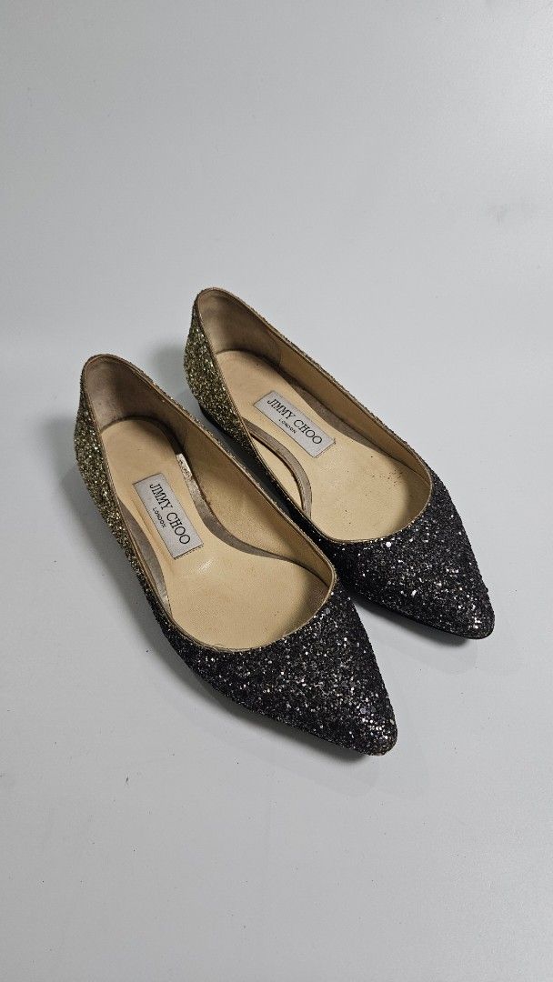 Jimmy Choo Glitter Pointed Toe Flats (Category: Flats & Sandals) located in Alfonso. Submitted by jbcamet (Listing ID 1468192679, Image 1). Description: - Brand: Jimmy Choo - Style: Pointed toe flats with stunning black-to-gold glitter fade - Size: 35.5 - Material: Leather lining and soles, crafted in Italy - Condition: Glitter exterior is fully intact; normal wear on the leather soles from walking - Perfect for adding sparkle to casual and dress