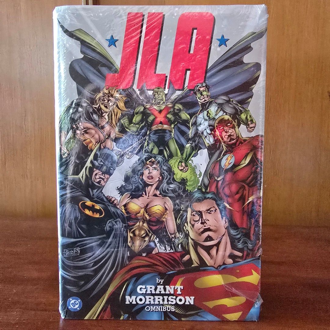 JLA by Grant Morrison Omnibus DC Comics Hardcover (Category: Comics & Manga) located in Quezon City. Submitted by winmadtrading (Listing ID 1468250968, Image 1). Description: - Title: JLA by Grant Morrison Omnibus Hardcover - Creators: Written by Grant Morrison with art by Howard Porter, John Dell, and Pat Garrahy - Contents: Collects the legendary JLA run plus JLA: Earth 2 and JLA: One Million event material - Condition: Massive hardcover volume