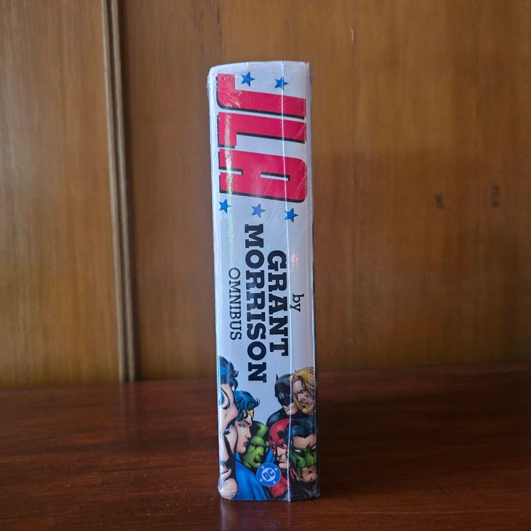 JLA by Grant Morrison Omnibus DC Comics Hardcover (Category: Comics & Manga) located in Quezon City. Submitted by winmadtrading (Listing ID 1468250968, Image 2). Description: - Title: JLA by Grant Morrison Omnibus Hardcover - Creators: Written by Grant Morrison with art by Howard Porter, John Dell, and Pat Garrahy - Contents: Collects the legendary JLA run plus JLA: Earth 2 and JLA: One Million event material - Condition: Massive hardcover volume