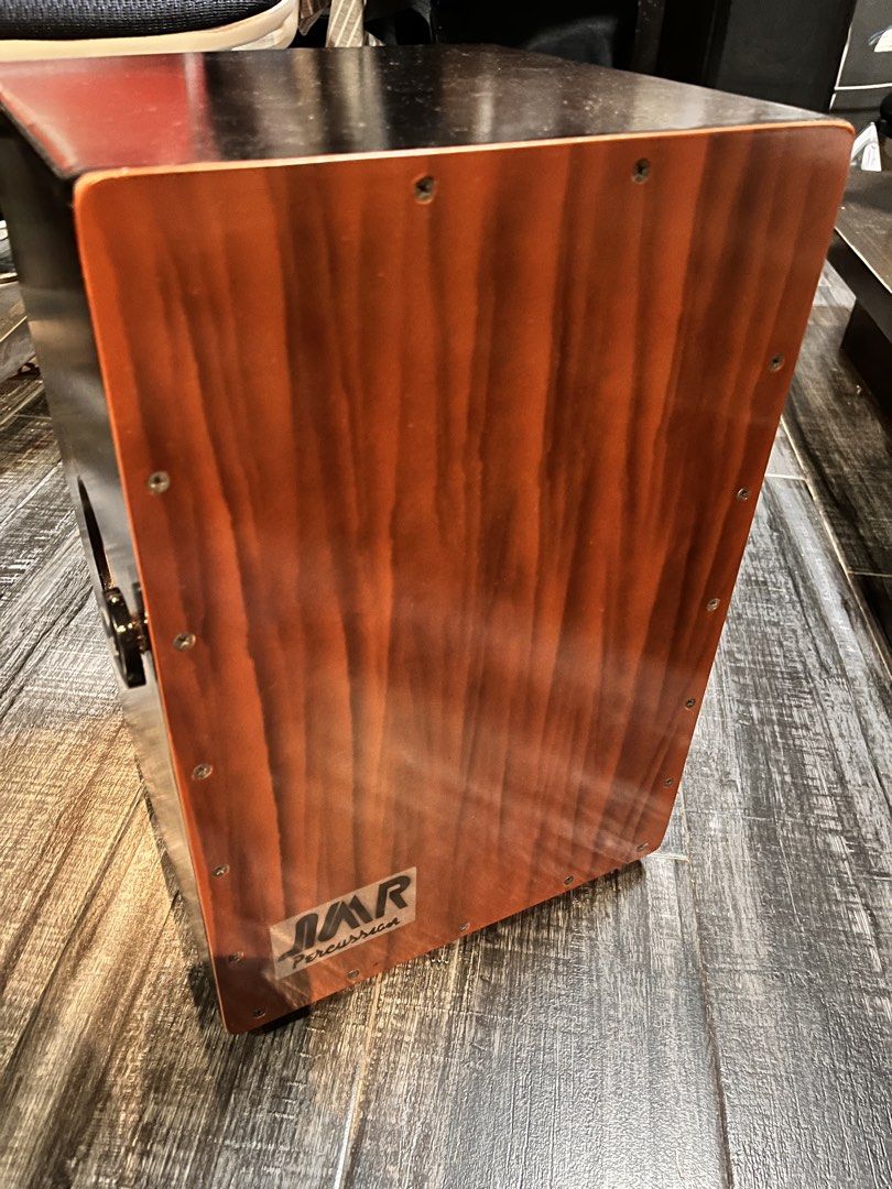 JMR Percussion Pickup Cajon with Carry Bag (Category: Musical Instruments) located in Taytay. Submitted by janecsb (Listing ID 1468180593, Image 3). Description: - Brand: JMR Percussion Acoustic-Electric Cajon - Electronics: Built-in pickup system with side tone/volume knobs and output jack - Aesthetics: Beautiful wood-grain striking surface with a matte black body and rear sound hole - Inclusion: Comes with original black zippered carrying bag w