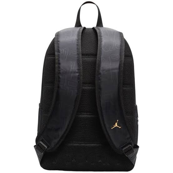 Jordan Black and Gold Monogram Backpack (Category: Backpacks) located in Mandaluyong City. Submitted by swiftbird_ed6c34 (Listing ID 1468101575, Image 3). Description: - Brand new, sealed in original plastic packaging with original tags attached - Sleek black design featuring all-over tonal debossed monogram lettering - Premium gold hardware accents, including the front zipper pull and iconic Jumpman logo badge - Comfortable breathable mesh back 