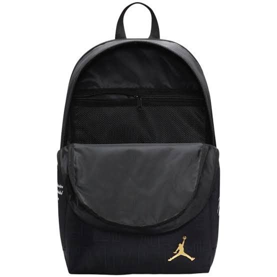 Jordan Black and Gold Monogram Backpack (Category: Backpacks) located in Mandaluyong City. Submitted by swiftbird_ed6c34 (Listing ID 1468101575, Image 2). Description: - Brand new, sealed in original plastic packaging with original tags attached - Sleek black design featuring all-over tonal debossed monogram lettering - Premium gold hardware accents, including the front zipper pull and iconic Jumpman logo badge - Comfortable breathable mesh back 