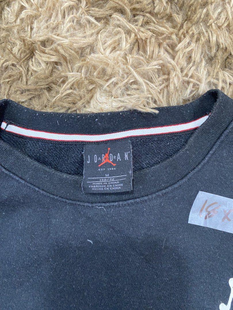 Jordan Black Sweatshirt (Category: Coats, Jackets and Outerwear) located in Cagayan de Oro. Submitted by sepamorash53558 (Listing ID 1468266418, Image 3). Description: - Brand: Jordan - Color: Black - Size: M (150/72) - Jumpman logo printed on the chest - Big Jordan lettering across the back shoulders issue lints - Colorful graphic patch near the bottom hem - Striped ribbing inside the collar - Comfortable pullover style for casual wear - Trusted