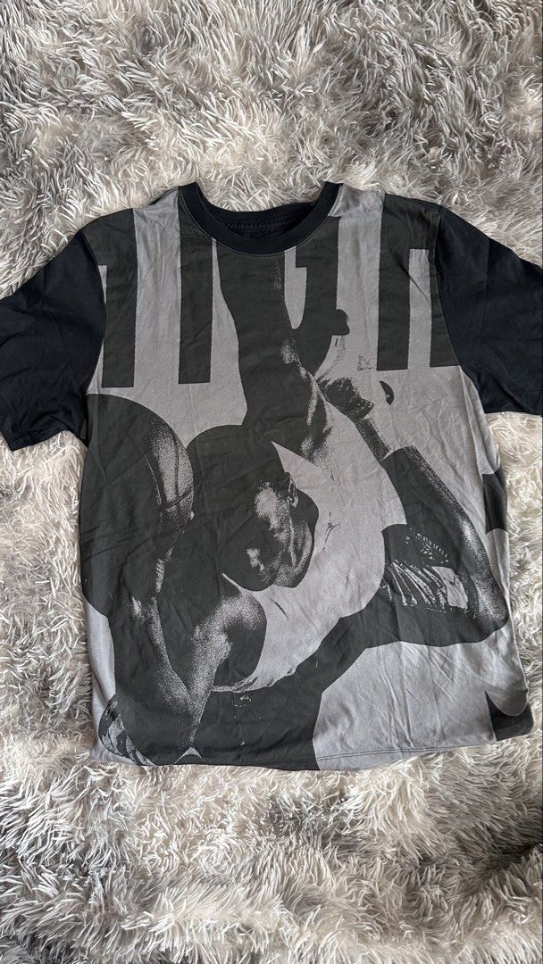 Jordan Graphic T-Shirt (Category: Tshirts & Polo Shirts ) located in Antipolo. Submitted by waco1313 (Listing ID 1468204718, Image 1). Description: - Brand: Jordan - Size: Medium - Design: Large Michael Jordan slam dunk graphic on the grey front panel with black sleeves - Details: Small red Jumpman logo on the left sleeve, classic crew neck - Material: 100% cotton, machine washable - Style: Standard fit, casual streetwear piece.