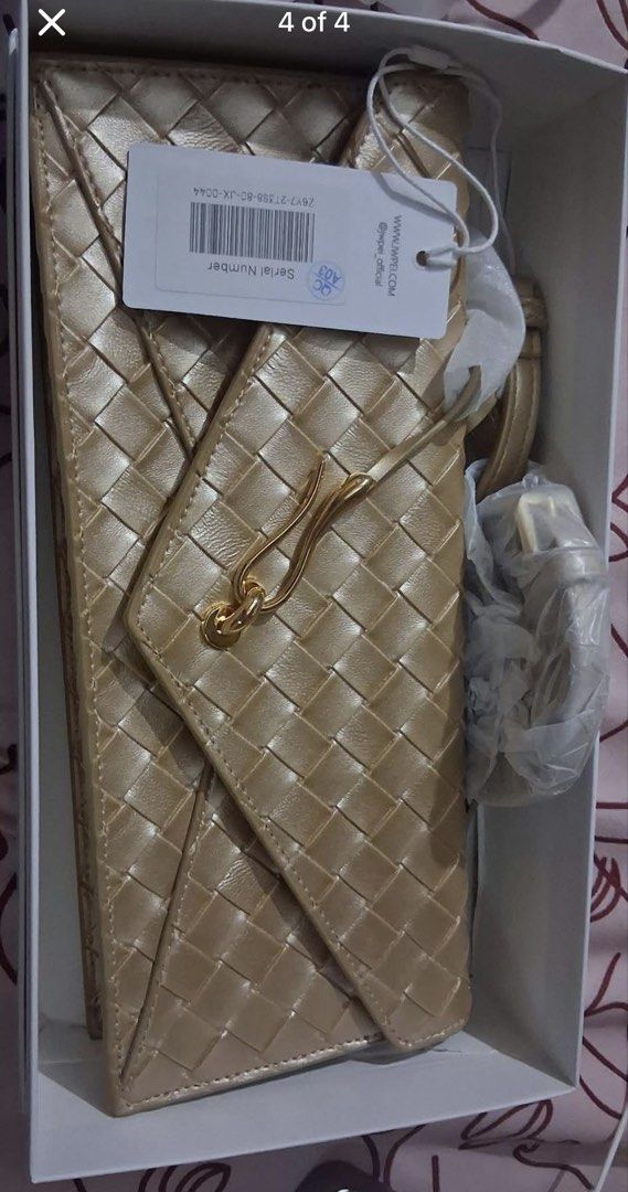 JW Pei Celeste Woven Textured Envelope Bag Gold (Category: Luxury Bags & Wallets) located in Cebu City. Submitted by uniquepreloved88 (Listing ID 1468153956, Image 3). Description: - Brand: JW Pei Celeste Envelope Bag - 9k original price - Color/Finish: Woven textured gold with gold-tone hardware - Condition: Brand new with tags attached, strap still wrapped in plastic - Inclusions: Original box and dust bag included - Features: Secure magnetic c