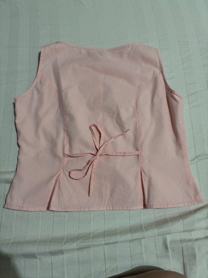 Kabello Pink Sleeveless Button-Down Blouse (Category: Sleeveless) located in Paranaque City. Submitted by intheaftrglw (Listing ID 1468198658, Image 2). Description: - Kabello pastel pink sleeveless blouse - Size: L - Button-down front with clear buttons - Adjustable matching tie string at the back waist.
