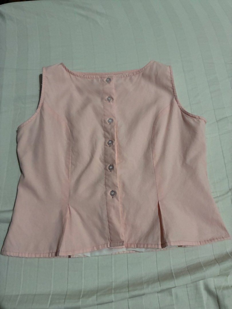 Kabello Pink Sleeveless Button-Down Blouse (Category: Sleeveless) located in Paranaque City. Submitted by intheaftrglw (Listing ID 1468198658, Image 1). Description: - Kabello pastel pink sleeveless blouse - Size: L - Button-down front with clear buttons - Adjustable matching tie string at the back waist.