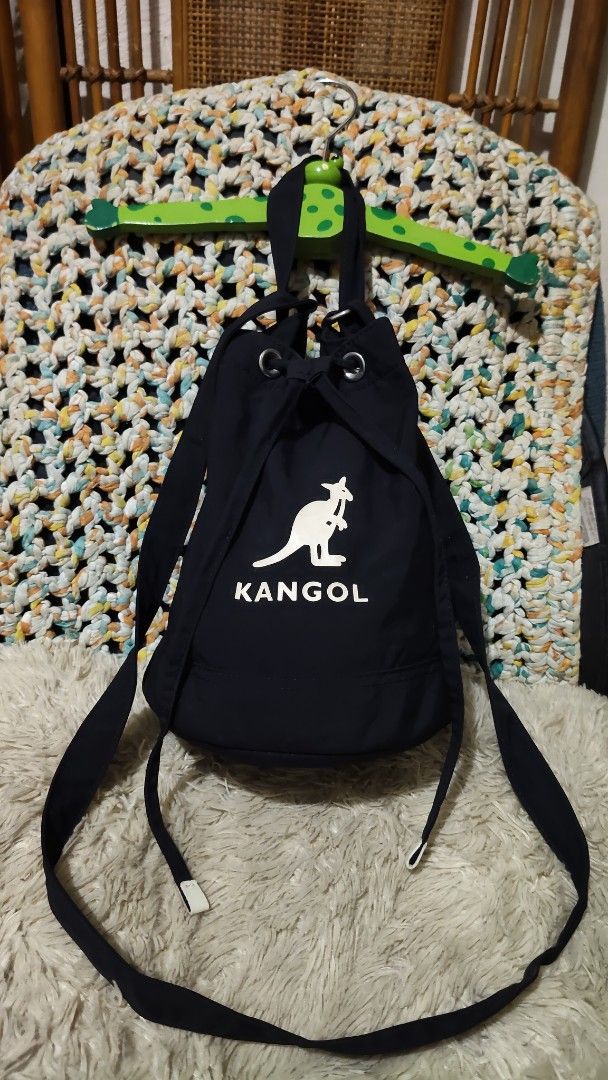 Kangol Black Drawstring Bucket Bag (Category: Cross-body Bags) located in Cebu City. Submitted by lumaynojes00490 (Listing ID 1468071421, Image 1). Description: - Brand: Kangol - Color: Classic black with white front logo - Closure: Secure drawstring with metal grommets - Versatile Carry: Includes a top grab handle and a long adjustable strap for shoulder or crossbody wear - Everyday Use: Spacious enough to fit all your daily essentials comfortab