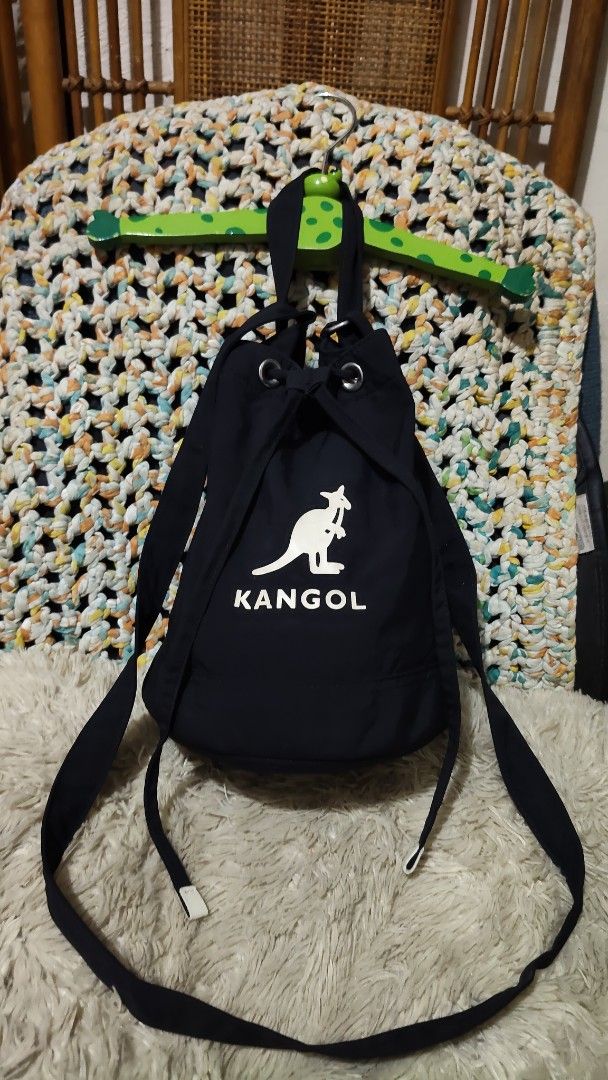 Kangol Black Drawstring Bucket Bag (Category: Cross-body Bags) located in Cebu City. Submitted by lumaynojes00490 (Listing ID 1468071421, Image 2). Description: - Brand: Kangol - Color: Classic black with white front logo - Closure: Secure drawstring with metal grommets - Versatile Carry: Includes a top grab handle and a long adjustable strap for shoulder or crossbody wear - Everyday Use: Spacious enough to fit all your daily essentials comfortab
